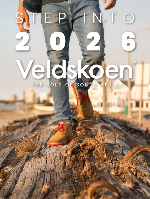 Person wearing Veldskoen shoes stepping onto a log with text 'Step into 2026 Veldskoen' in the foreground.